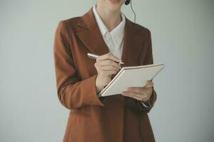Beautiful female call center operator working on computer in office photo