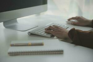 Beautiful female call center operator working on computer in office photo