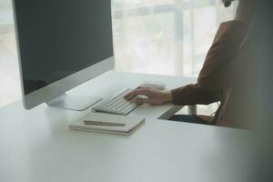 Beautiful female call center operator working on computer in office photo