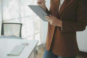 Beautiful female call center operator working on computer in office photo