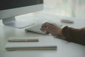 Beautiful female call center operator working on computer in office photo