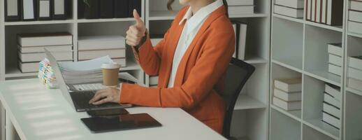 Beautiful female call center operator working on computer in office photo