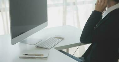 Beautiful female call center operator working on computer in office photo