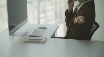 Beautiful female call center operator working on computer in office photo