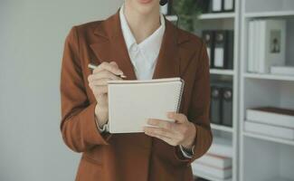 Beautiful female call center operator working on computer in office photo