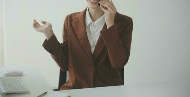 Beautiful female call center operator working on computer in office photo