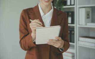 Beautiful female call center operator working on computer in office photo