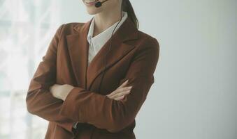 Beautiful female call center operator working on computer in office photo