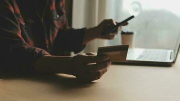 Online payment,businessman hands holding credit card and using laptop for online shopping. Cyber Monday Concept photo