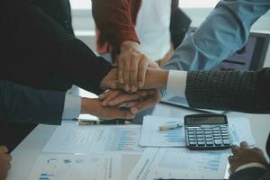 Large business team showing unity with their hands together photo