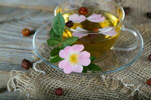 Rose hip herbal tea on a wooden surface. Free text. photo