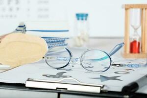 Eyeglasses for children on a eye chart close to eye pads. photo