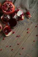Glass of pomegranate juice on a wooden surface. photo