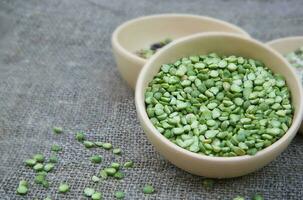 Dried green peas in a clay dish photo