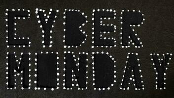 Words CYBER MONDAY on black carton paper photo