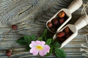 Fresh rose hip on a wooden surface. photo