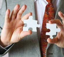 Puzzle in the hands of a man in a classical costume photo