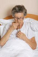 Old woman is praying in the bed photo