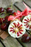 Cherry vanilla ice-cream with caramel topping. Closeup photo