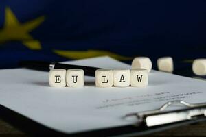 Words EU LAW composed of wooden dices. photo