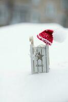 Santa Claus hat on a wooden made sleigh. photo