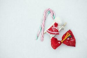 Christmas candies and mini Santa Claus hat. Flat lay photo