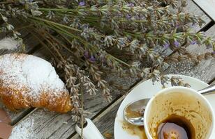 A dirty cup after coffee on a wooden surface. photo