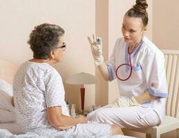 Geriatrician visits a senior woman photo