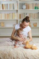 Young mother with her one year old daughter. photo