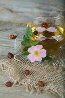 Rose hip herbal tea on a wooden surface. Free text. photo