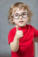 A boy shows his index finger. Closeup photo