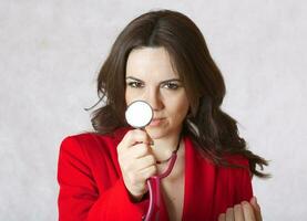 Young woman with a stethoscope. Closeup photo