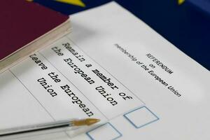 EU Referendum ballot paper, black pen, and passport on the table. photo