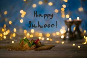 Happy Suhoor Happy pre-dawn meal Arabic sweets on a wooden surface. photo