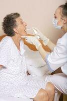 Geriatrician visits a senior woman photo