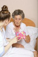 Geriatrician visits a senior woman photo