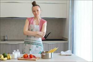 Young housewife in the kitchen photo