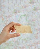 Piece of paper with free space for a text on a map. photo