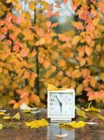 Old square alarm clock on a marble stone covered by rain. photo