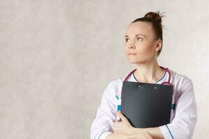 Young female doctor dressed in a white medical uniform photo