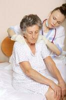 Geriatrician visits a senior woman photo