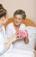 Geriatrician visits a senior woman photo