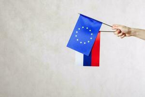 A hand with two flags - EU and Russia photo