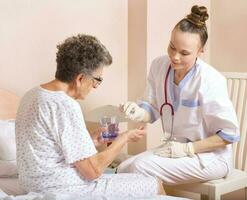 Geriatrician visits a senior woman photo