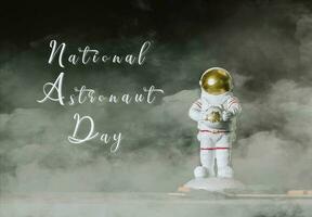 National Astronaut Day. Astronaut keeps earth in his hands. photo