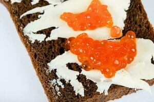 Cereal black bread with butter and red caviar. photo