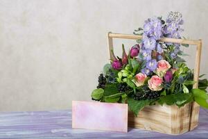 Woodenmade basket with beautiful flowers. photo