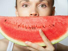 Young lady with a slice of water melon. Closeup photo