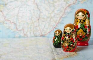 Russian matryoshka in khokhloma style on a map. Closeup photo