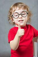 A boy shows his finger. Closeup photo